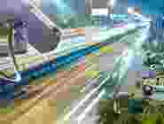 High-speed train gliding through a modern cityscape at night. High-speed train gliding through a modern cityscape at night.