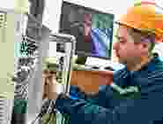 Technician repairing an electronic device with tools. Technician repairing an electronic device with tools.