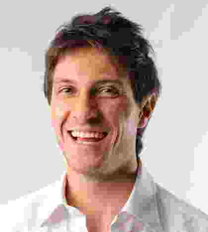 Smiling man with short brown hair and casual attire. Smiling man with short brown hair and casual attire.