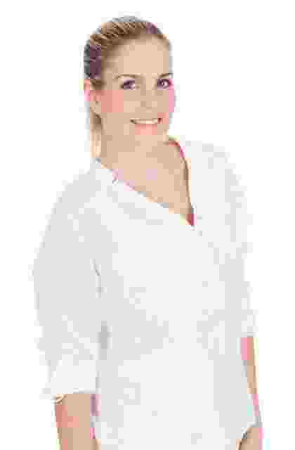 Smiling woman in a white lab coat, suggesting a medical or professional setting. Smiling woman in a white lab coat, suggesting a medical or professional setting.