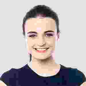 Smiling young woman with dark hair in a navy blue top. Smiling young woman with dark hair in a navy blue top.