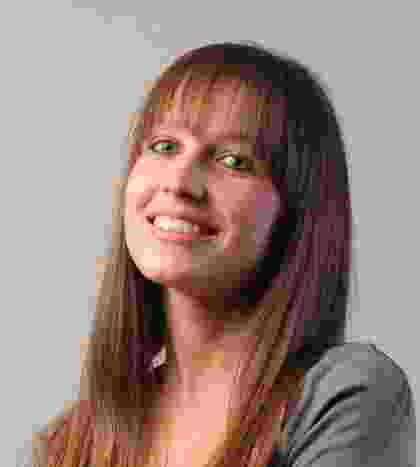 Young woman with long brown hair smiling against a plain background. Young woman with long brown hair smiling against a plain background.