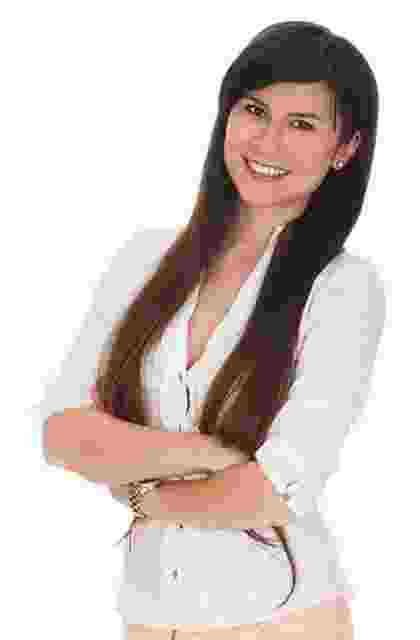 Smiling woman with long hair in white top, arms crossed. Smiling woman with long hair in white top, arms crossed.