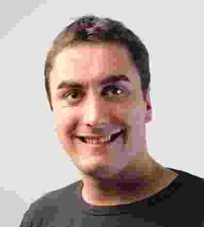 Smiling man with short dark hair in a dark shirt. Smiling man with short dark hair in a dark shirt.