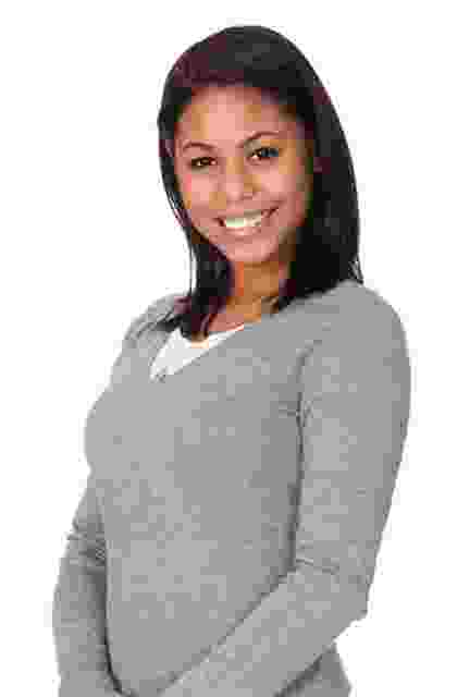 Smiling woman in a gray sweater posing for the camera. Smiling woman in a gray sweater posing for the camera.