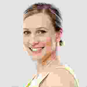 Smiling woman with short hair against a neutral background. Smiling woman with short hair against a neutral background.