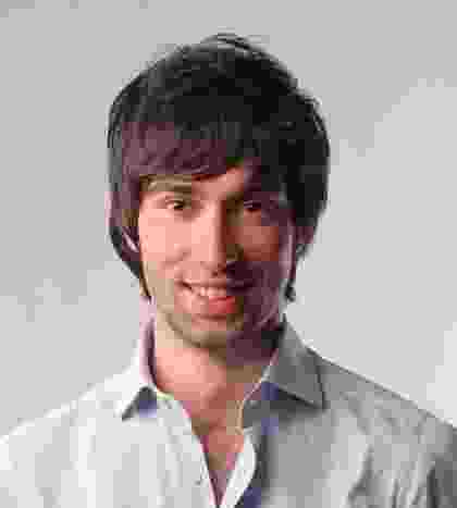 Portrait of a man with dark hair and a slight smile. Portrait of a man with dark hair and a slight smile.