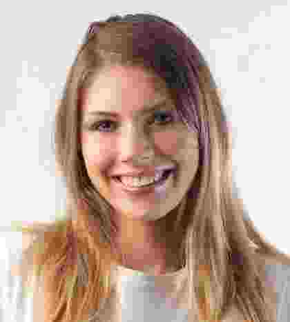 Smiling young woman with long blonde hair against a white background. Smiling young woman with long blonde hair against a white background.