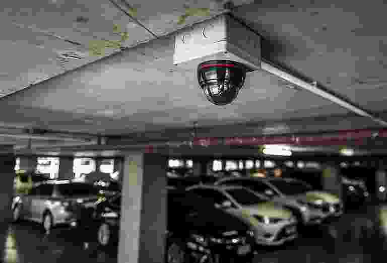 Security camera monitoring an indoor parking garage. Security camera monitoring an indoor parking garage.