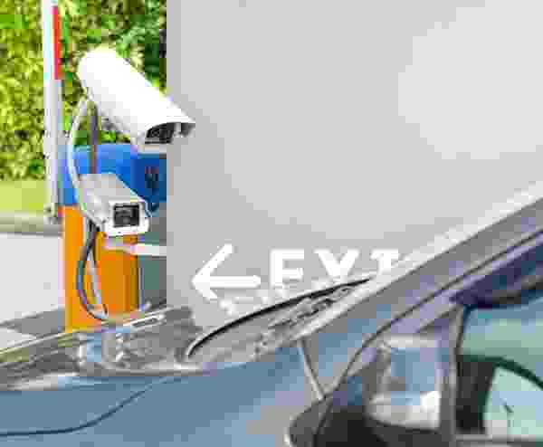 Security camera monitoring a parking area with a car nearby. Security camera monitoring a parking area with a car nearby.