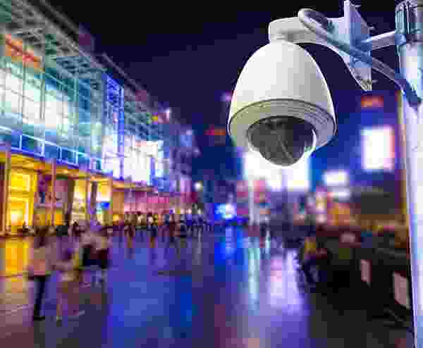 Security camera overlooking a busy, colorful city street at night. Security camera overlooking a busy, colorful city street at night.
