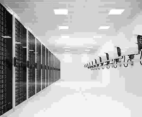 A modern data center server room with racks and cooling units. A modern data center server room with racks and cooling units.
