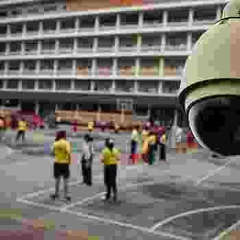 Security camera overlooking people in a courtyard. Security camera overlooking people in a courtyard.