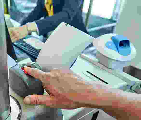 Person using a fingerprint scanner for identity verification. Person using a fingerprint scanner for identity verification.