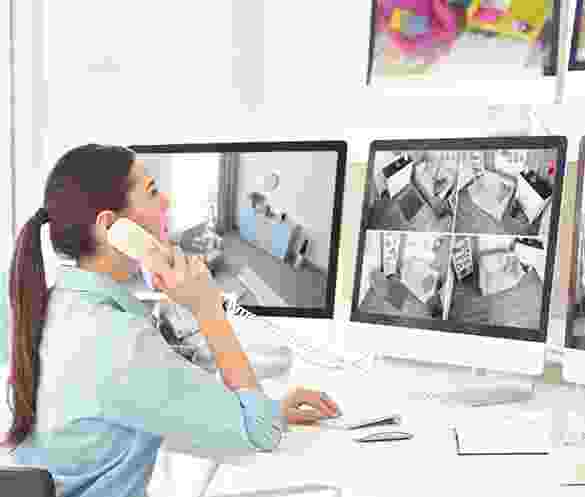 Security guard monitoring surveillance footage on multiple screens. Security guard monitoring surveillance footage on multiple screens.