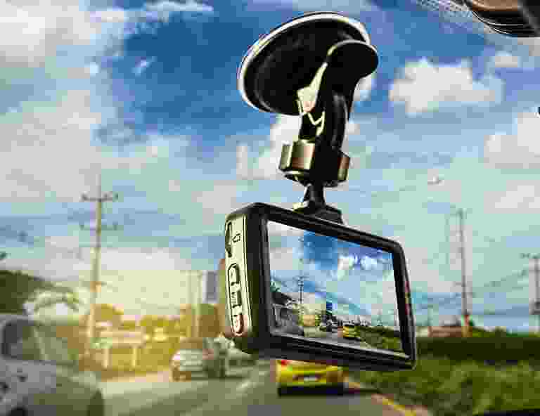 A car dashboard camera mounted on the windshield recording traffic. A car dashboard camera mounted on the windshield recording traffic.