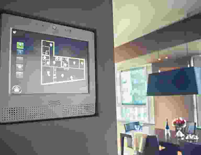 Modern home office with a digital floor plan on a wall screen. Modern home office with a digital floor plan on a wall screen.