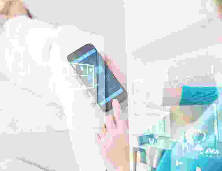 Person holding smartphone displaying app icons and text. Person holding smartphone displaying app icons and text.