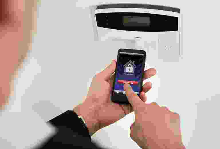 Person scanning QR code with a smartphone at a device. Person scanning QR code with a smartphone at a device.