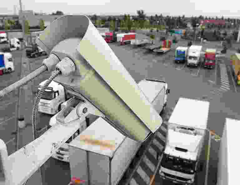 A security camera overlooking a busy truck parking lot. A security camera overlooking a busy truck parking lot.