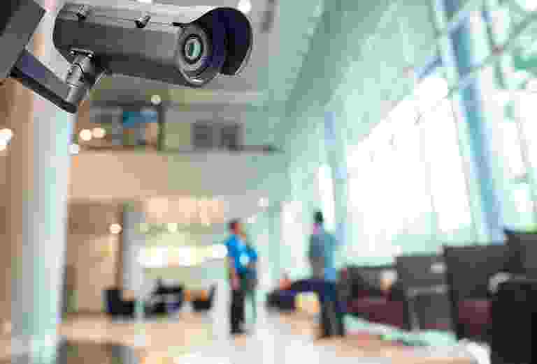 Security camera overlooking a waiting area with two people. Security camera overlooking a waiting area with two people.
