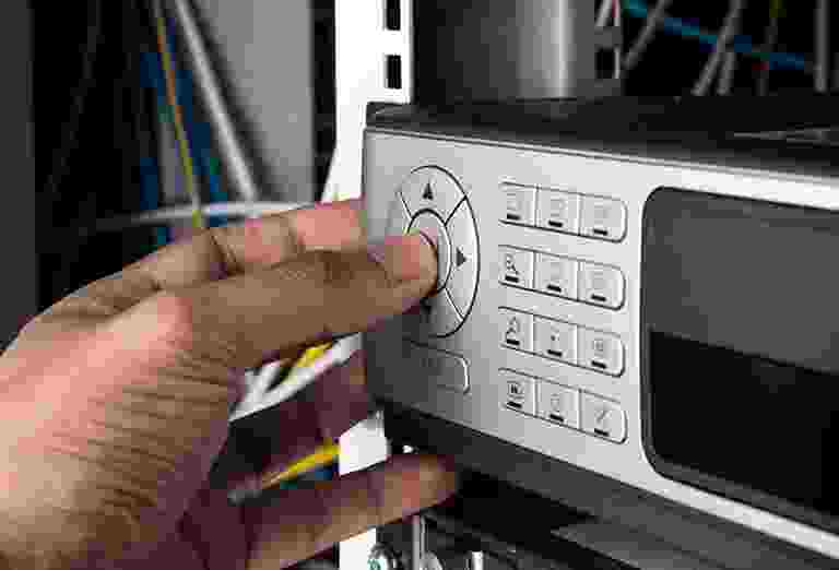 Hand pressing a button on a security alarm keypad. Hand pressing a button on a security alarm keypad.