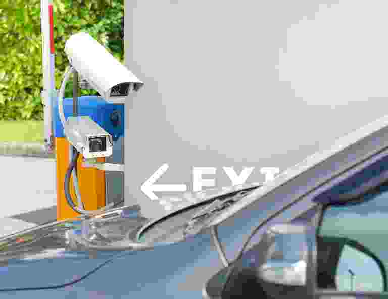 Electric car charging station with a sign pointing left for EV charging. Electric car charging station with a sign pointing left for EV charging.