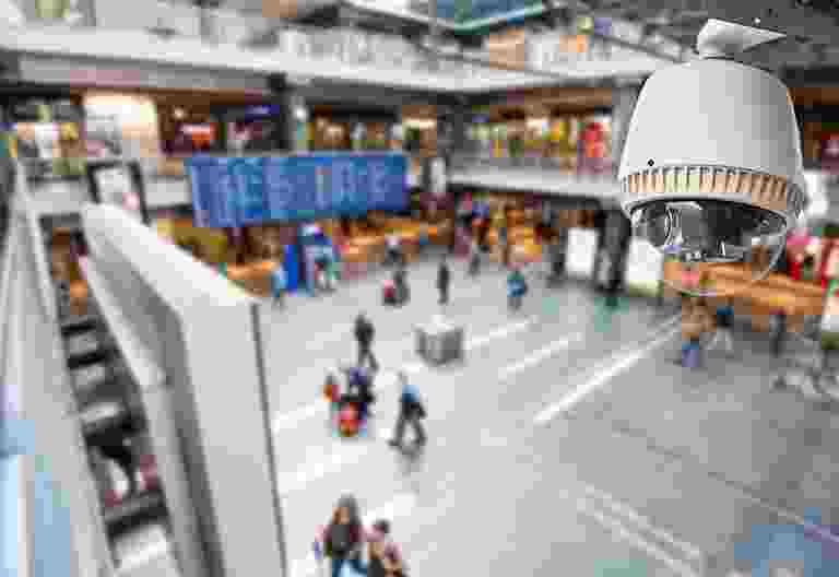 Busy indoor shopping mall with shoppers and stores. Busy indoor shopping mall with shoppers and stores.
