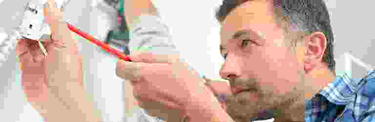Man intensely inspecting a small object in his hand. Man intensely inspecting a small object in his hand.