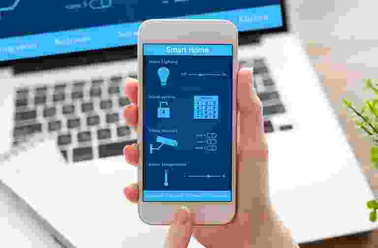 Smartphone displaying a home automation app controlling lighting and climate. Smartphone displaying a home automation app controlling lighting and climate.